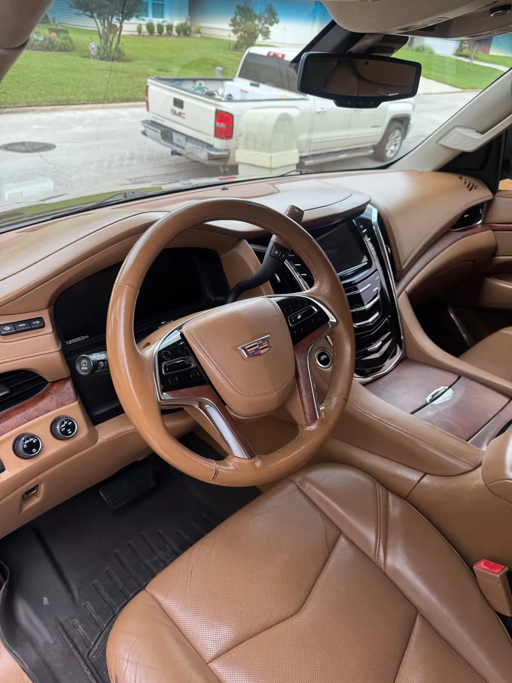 Cadillac Escalade dash and front seats in tan leather after a detail