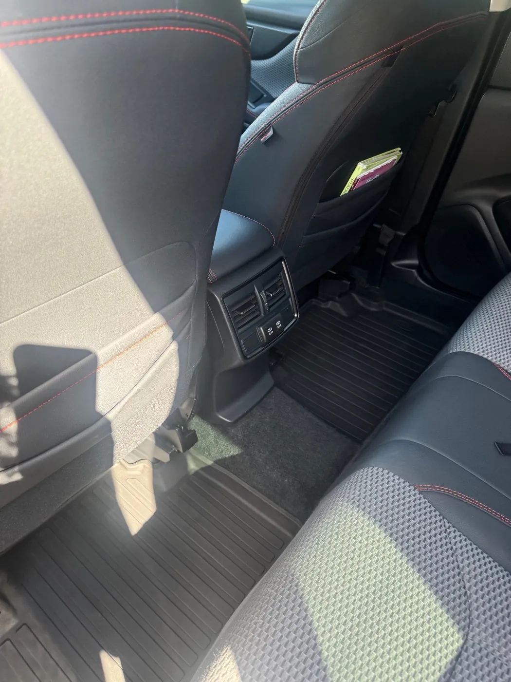 Rear floor and seat back with red stitching after an interior detail
