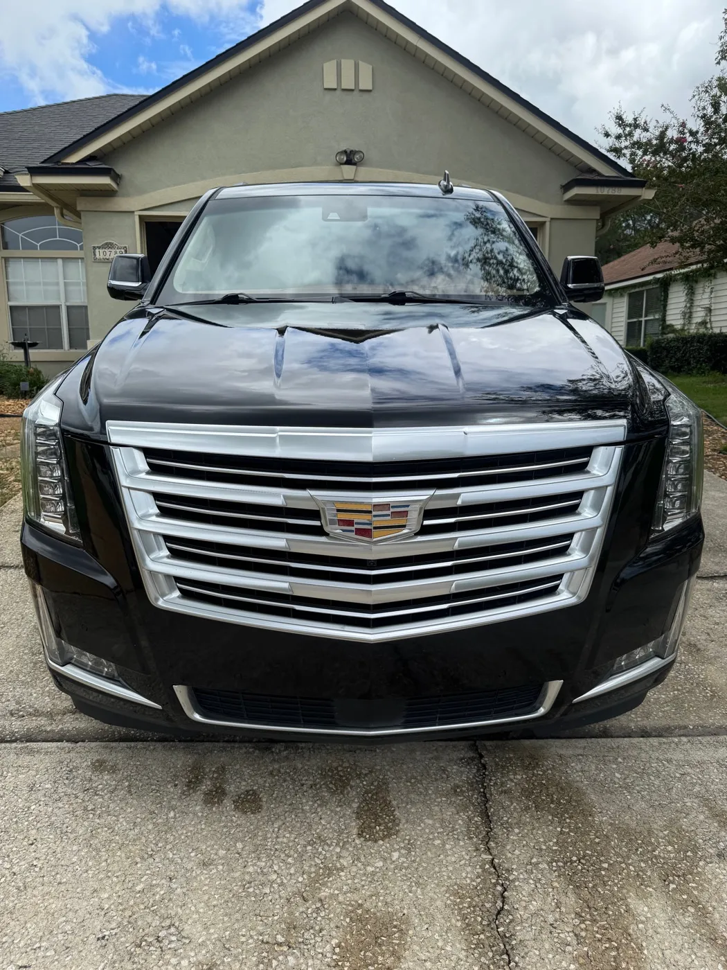 Black Cadillac Escalade parked in a driveway after a detail