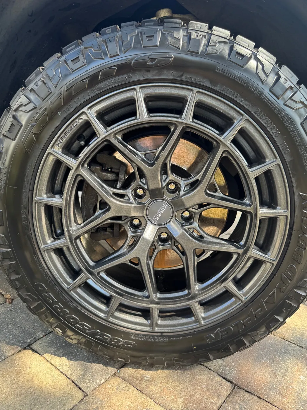 Gray wheel and dressed off-road tire after a detail
