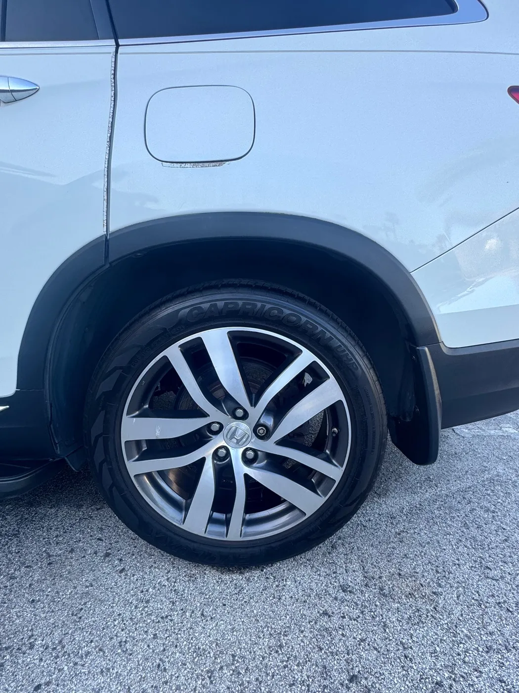Clean wheel and tire on a white SUV after a detail